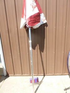 lot 12 image: Leinenkugel vinyl patio umbrella. Good used condition. As shown.