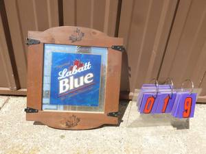 lot 19 image: Labatt Blue wood frame mirror. 15 x 17 . Has 12 hinges on sides. As shown.
