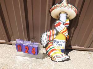 lot 24 image: Corona extra tin sign 23 x 12. Looks to be unused. As shown.