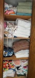 lot 74 image: Contents of Linen Closet HandKitchenBath Towels, Aprons