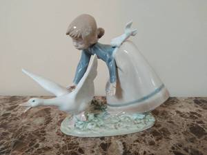 lot 21 image: Lladro Wild Goose Chase Girl and Goose Figurine