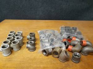 lot 2138 image: Lot of (49) Steel Pipe Fittings - (16) 1-14 45° Elbows, (9) 1-14 x 12 x 1-14 Reducing Tees, (6) 1-14 90° Street Elbows, (15) 1-14 Couplers and More