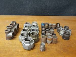 lot 2147 image: Lot of (36) Steel Pipe Fittings - (9) 1-12 Unions, 1-14 Tees, Nipples and Reducers