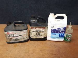 lot 2165 image: (3) Partial Jugs of Mineral Oil and Bottle of Vacuum Pump Oil