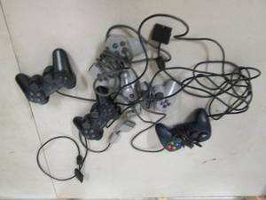 lot 219 image: 4 playstation remotes and a logitec...