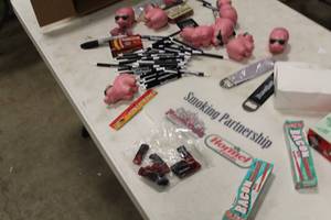 lot 749 image: Lot of Famous Daves Memorabilia  - Pigs with Sunglasses, Hormal Food Signs, Mr. Bacons Bacon Flavored Toothpaste, Pens, Bandages, and more