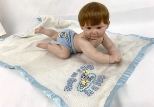 lot 86 image: Ashton-Drake Porcelain Doll - Snug as a Bug in a Rug