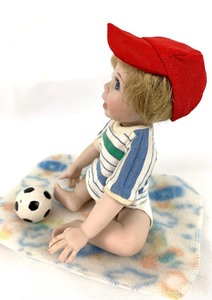 lot 87 image: McCory Collectible Porcelain Boy Doll with Soccer Ball and Blanket