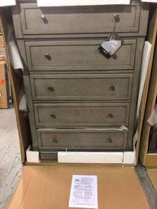 lot 28 image: Lettner Light Gray Five Drawer Chest & Wyndahl Brown Five Drawer Chest both are damaged on back side  see all pictures
