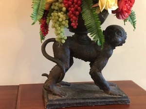 lot 102 image: Faux Floral Arrangement with a Monkey Vase