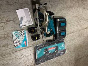 lot 108 image: 18-Volt X2 LXT Lithium-Ion (36-Volt) Brushless Cordless Rear Handle 7-14 in. Circular Saw wBONUS 5.0Ah Battery 2 Pack by Makita Customer Returns See Pictures
