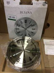 lot 92 image: 13 in. H x 13 in. W Wall Clock in Brushed Stainless Steel Finish by Bulova &nbspCustomer Returns See Pictures
