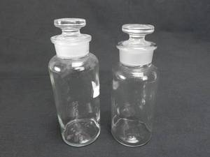 lot 59 image: Set of 2 Vintage T.C.W. Company And MBW 500 ML Wide Mouth Glass Bottles With Stoppers
