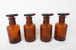 lot 136 image: Set of 4 Vintage T.C.W. Company 60 ML Amber Glass Dropping Bottles With Stoppers