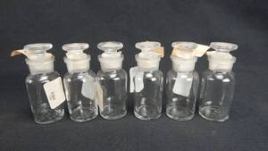 lot 168 image: Set of 6 Vintage T.C.W. Company 30 ML Wide Mouth Glass Bottles With Stoppers