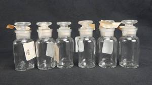 lot 170 image: Set of 6 Vintage T.C.W. Company 30 ML Wide Mouth Glass Bottles With Stoppers