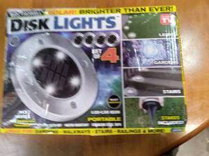 lot 114 image: Bell Howell Solar disk lights. 4 li...