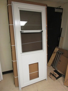 lot 205 image: PRO-VIA  ALUMINUM STORM DOOR W PET DOOR HOLE