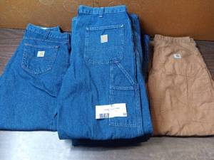 lot 33 image: 8 Pairs of Carhartt Jeans- 1 34x30 Carpenter Jeans, 5 34x32 Carpenter Jeans, 1 34x32 Khaki Jeans, 1 43x30 BRAND NEW WITH TAGS Carpenter Jeans,