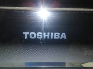 lot 15 image: 55 in. Toshiba Flat Screen TV with wall Mount and Remote.