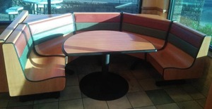 lot 87 image: 8 Person Corner Booth, Wood Grain Laminate, steel structure support.