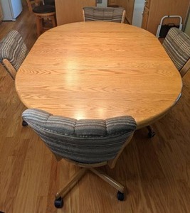 lot 376 image: Beautiful Oak RoundOval Pedestal Extending Farmhouse Table w 6 Rolling Chairs