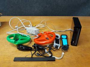 lot 150 image: Nintendo Wii - W (2) Controllers, (2) Steering Wheels, (2) Nunchucks, Power Supply, AV Cord & Sensor Bar