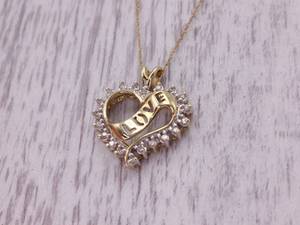 Heart Shaped Diamond Pendant With Love Ribbon in Yellow Gold