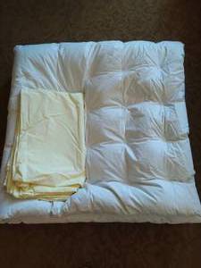 Down comforter from Germany with yellow envelope style covering.