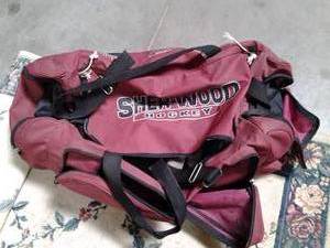 Large duffle bag with hockey gear. ...