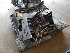 lot 369 image: Lot of Police Squad Car Equipment (on pallet)  - Divider Cages, DVD Recorder, Brackets, Console Pieces, Wiring Harness, Misc. Squad Car Equipment
