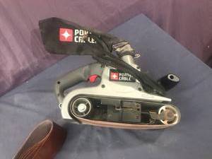 lot 145 image: Porter Cable Variable Speed Belt Sander with Extra Belts