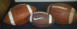 3 Footballs. Nike Jr., Wilson, and Rawlings full size.