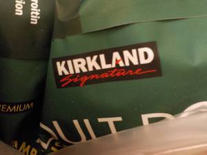 lot 297 image: Kirkland 40 lb. dog food - open bag...