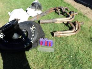 Header set appears solid. Extra 1 is cracked. For 350 Chevrolet. Man cave race tire & rim. 2 shop lube pumps. As shown.