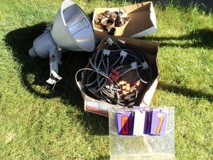 Flat of hole saws, v-belts & wheel chain yard lights. As shown.
