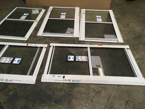 lot 21 image: Lot of 5 28 in. x 47 in. 2-Track Single Hung Aluminum Storm Window by LARSON Customer Returns See Pictures