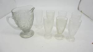 lot 60 image: Iris Herringbone Depression Glass Water Pitcher & 7 Footed Tumblers