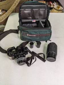 lot 192 image: Vintage Minolta Maxxum 3XL Camera with Lenz, Film, and Tamrac Case