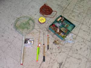 lot 240 image: Vintage Tackle Box Full of Tackle, Reels, Net, Ice Fishing Poles, Etc.