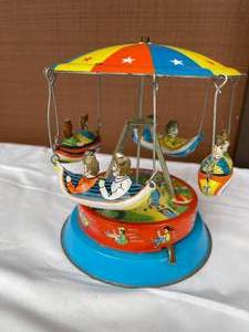 lot 136 image: Vintage Tin Boat Themed Merry Go Round Toy