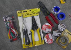 lot 131 image: Electricians tool set wire strippers, electrical tape pipe tape, test leads
