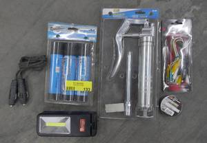lot 133 image: New mini grease gun, 3 tubes of trailer grease, cigarette lighter adapters, test leads, led light, electrical tape