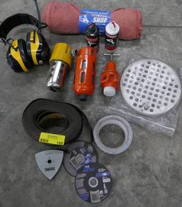 lot 168 image: 2 rolls of sanding paper, metal cutting blades, drain cover, air line treatment, ear covers, oil and shop rags
