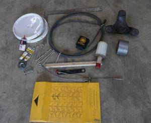 lot 171 image: Pro Park mat, small furniture moving dolly, hooks, square, shrink wrap , duct tape, pail covers, grabber, drain snake, long ruler