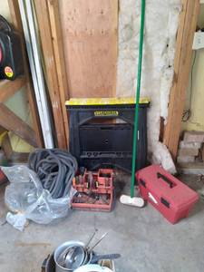 2 saw horses, bin of tools, and emp...