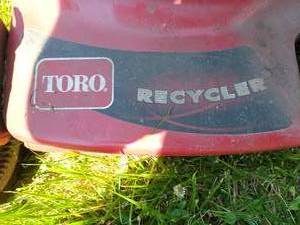 lot 116 image: Toro lawn mower with gas can and bagger