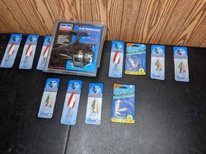 lot 214 image: Lot of (11) New Fishing Lures and (1) New Daiwa Long Cast Reel