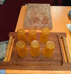 lot 39 image: (6) Vintage Plastic Cups, Solid Wood Cutting Board, Large Wooden Tray w Cork Handles