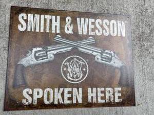 lot 72 image: Smith and Wesson Spoken Here Metal Sign